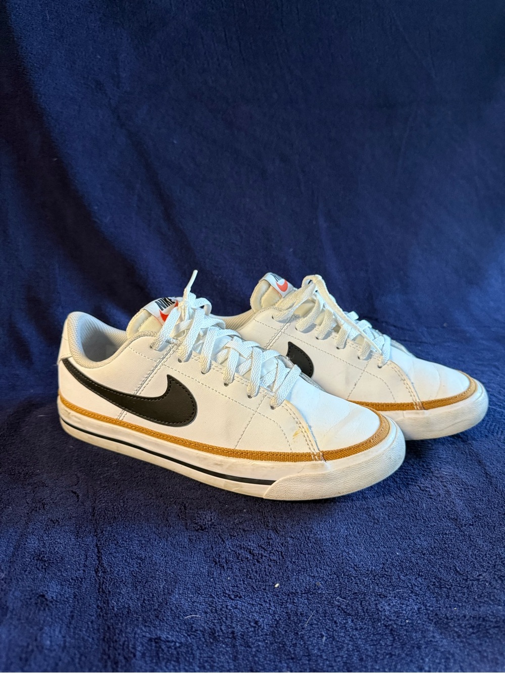 Nike Men’s White Low-Top Sneakers with Black Swoosh and Gold Trim